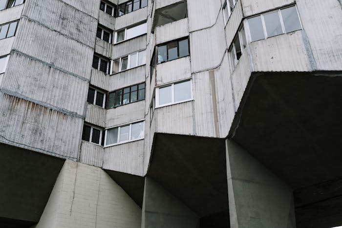 &ldquo;A raw concrete housing block highlighting the sharp geometry, exposed materials, and imposing mass that define Brutalist architecture.&rdquo;  Photographer credit (Pexels)  Photo by cottonbro studio on Pexels
