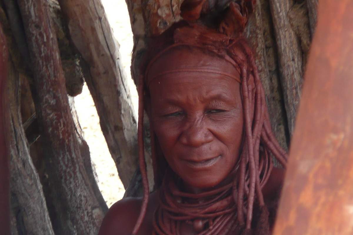 Himba woman painted in deep red paste called ojitze