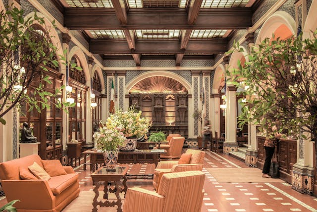 Photo by Iván Rivero- https-//www.pexels.com/photo/orange-fabric-sofa-with-three-throw-pillows-near-black-potted-plant-1001965