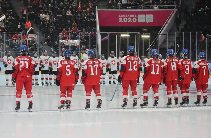 The Swiss ice hockey team (white) lines up on the ice to face the Czech Republic (Red) squad during the Lausanne 2020 Youth Olympic Games. Photo by Martin Rulsch on Wikimedia Commons (CC BY-SA 4.0)  .jpg
